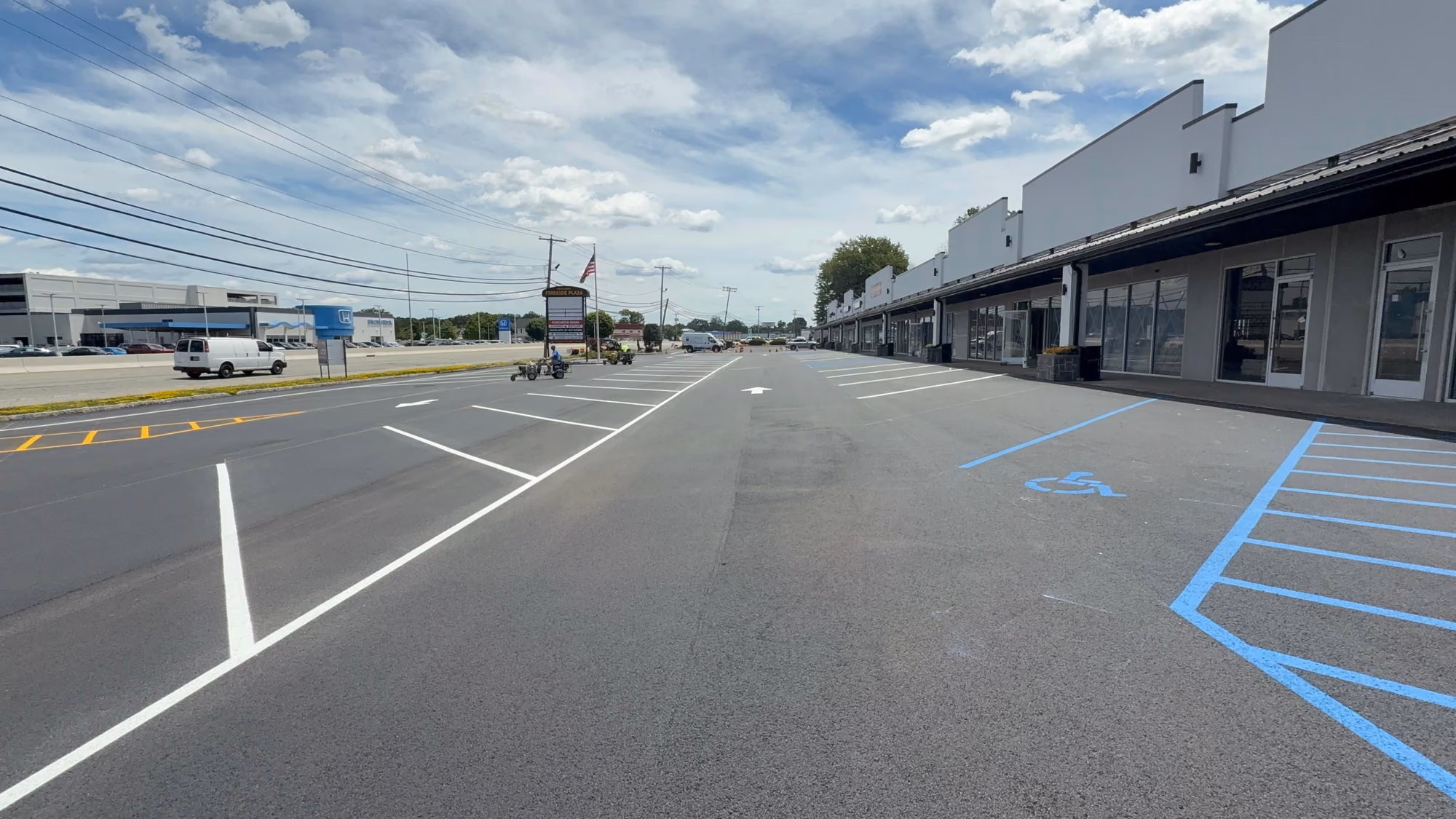Today — Renovation underway — an updated façade and a newly repaved, restriped parking field.